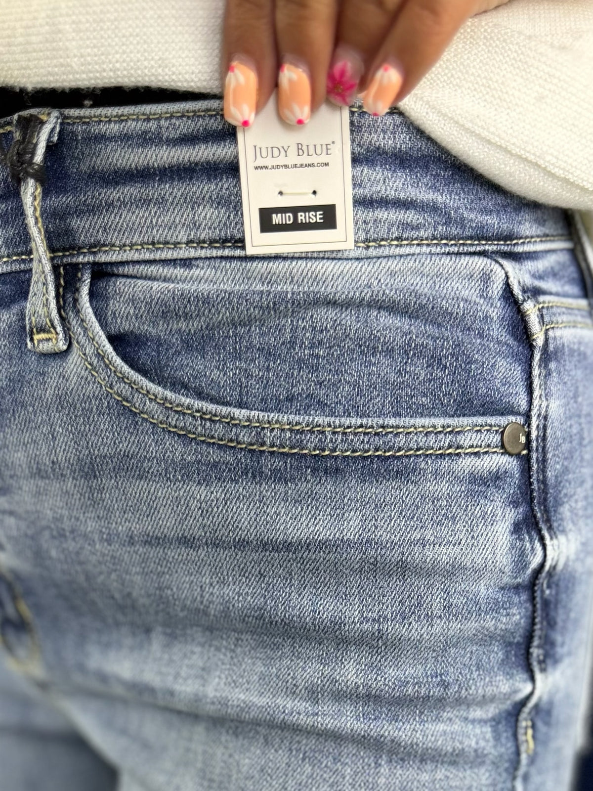 Close-up of blue jeans with a Judy Blue label on a blurred background