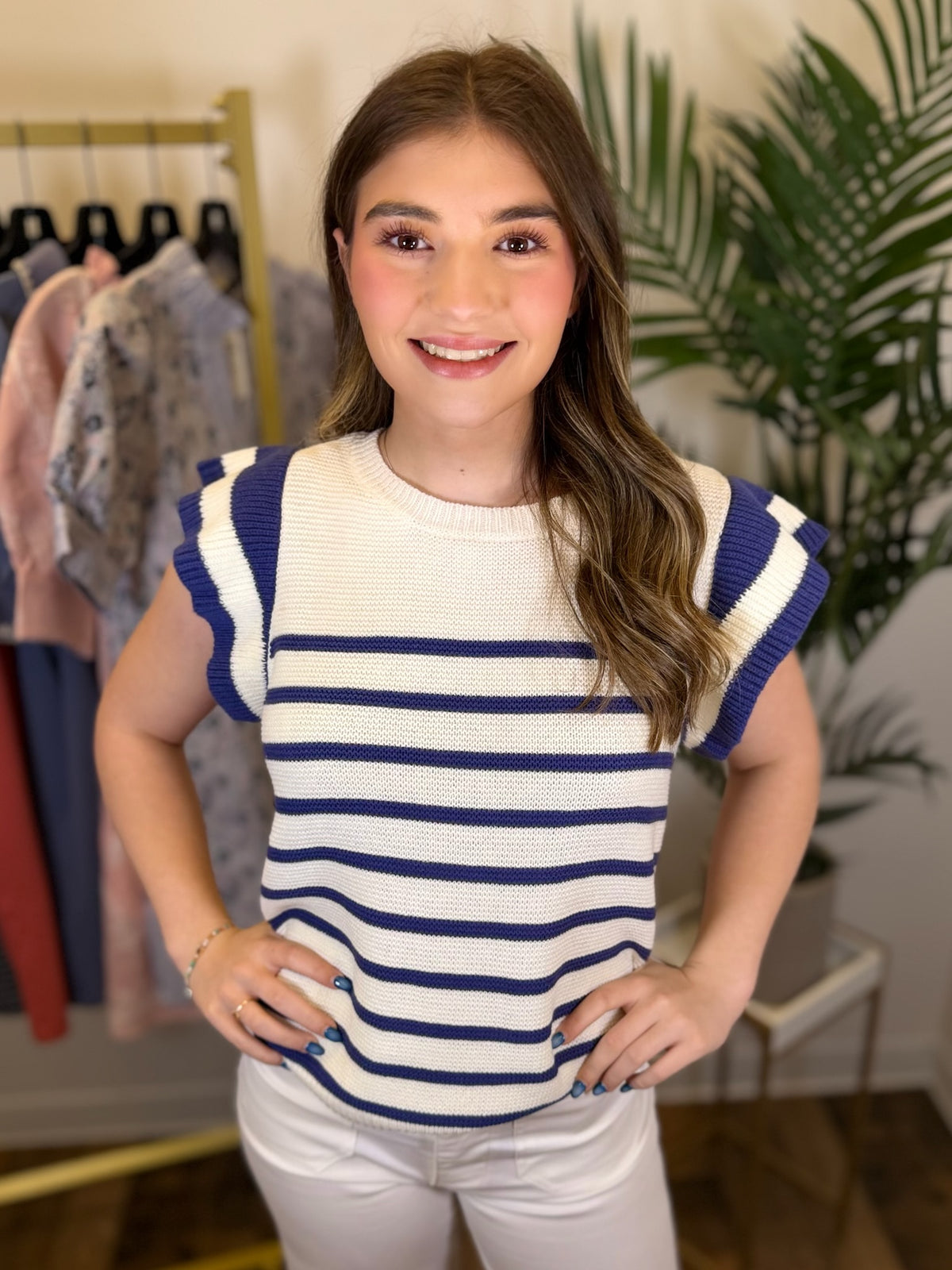 Woman wearing a striped shirt in a clothing store setting