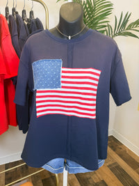 Navy blue vintage wash shirt with American flag design on a mannequin in a store setting.