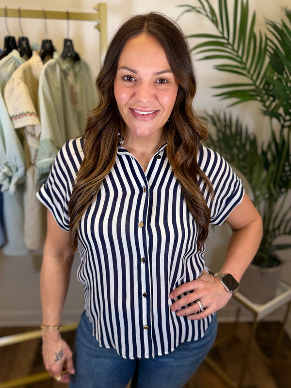 Woman wearing a navy and white striped shirt in a clothing store setting
