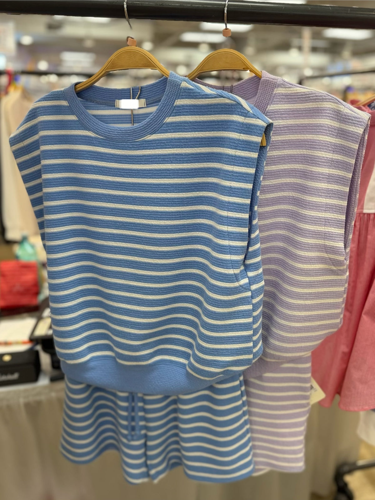 Coordinating knit set with cap sleeve top and shorts in striped print on hangers.